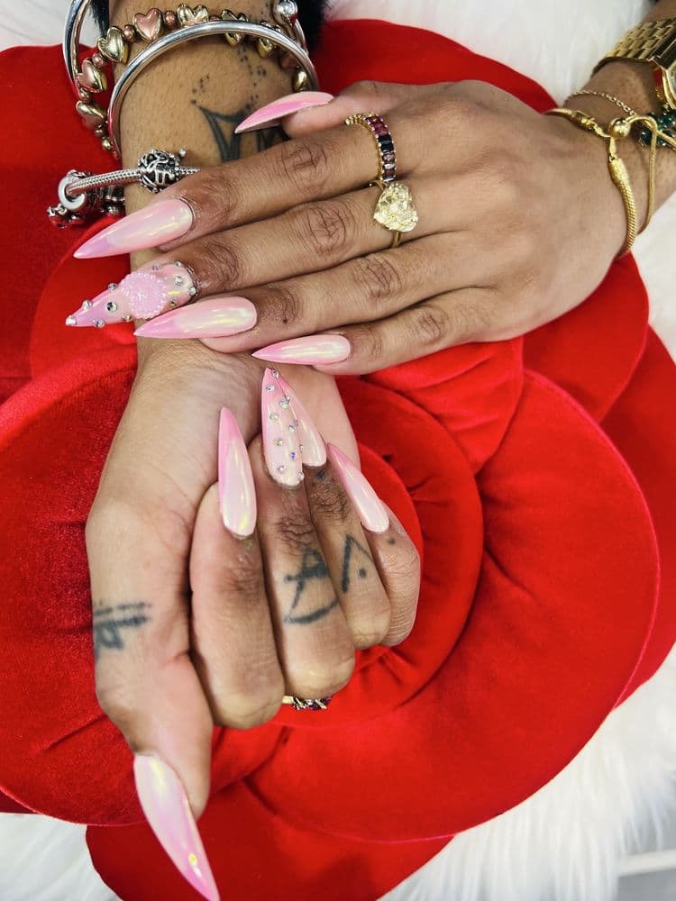 Long pink stiletto acrylic nails with aurora chrome effect and rhinestone accents by Nails by Ken