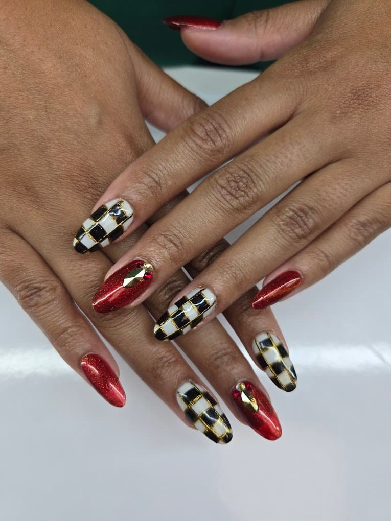 Almond nails with red holographic and black and white checkerboard nail art with crystals by Nails by Ken