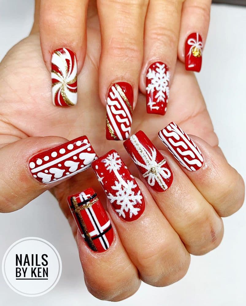 Long coffin nails with red and white Christmas nail art — snowflakes, candy canes and sweater pattern by Nails by Ken